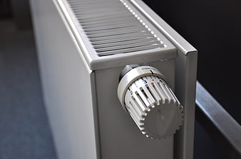 Close-up of white radiator thermostat control knob