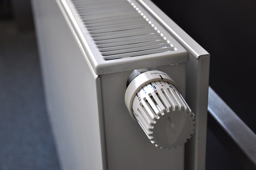 Close-up of white radiator thermostat control knob