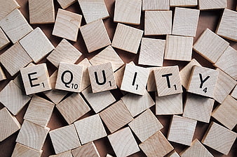 Wooden Scrabble Tiles Spelling Equity on Brown Background