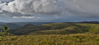 Panoramic View of Rolling Hills and Dramatic Cloudy Sky