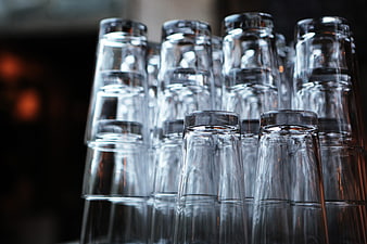 Stacked Clear Drinking Glasses in a Bar Setting