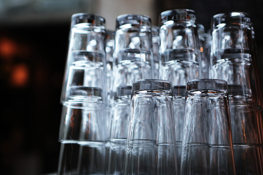 Stacked Clear Drinking Glasses in a Bar Setting