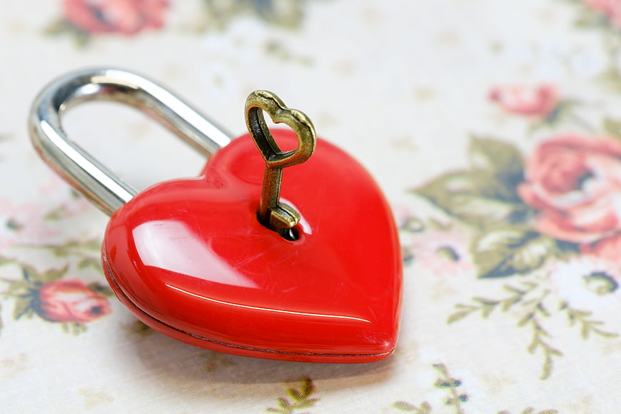 Red Heart Padlock With Brass Key On Floral Background