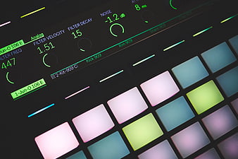 Close-up of colorful electronic music controller pads and display
