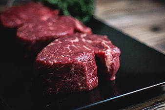 Raw Beef Steaks on Black Slate Board