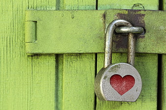 Weathered Padlock With Red Heart On Green Wooden Gate