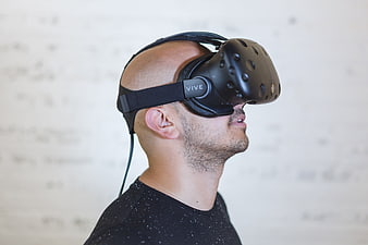 Man wearing HTC Vive virtual reality headset in profile