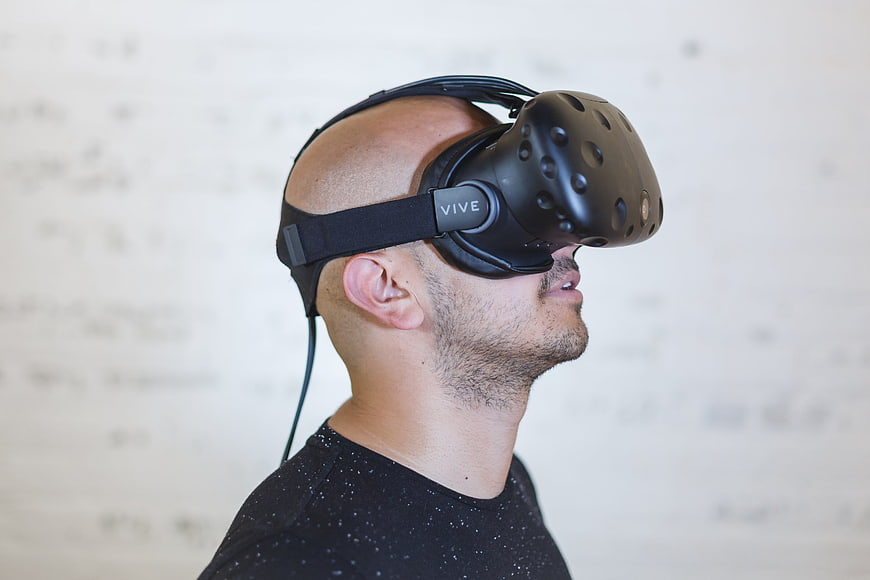 Man wearing HTC Vive virtual reality headset in profile