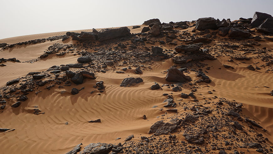 Rocky Desert Dune Landscape With Wind-Sculpted Sand Ripples