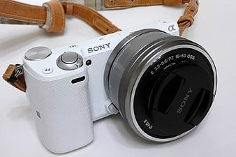 White Sony Alpha Camera with Leather Strap on White Background