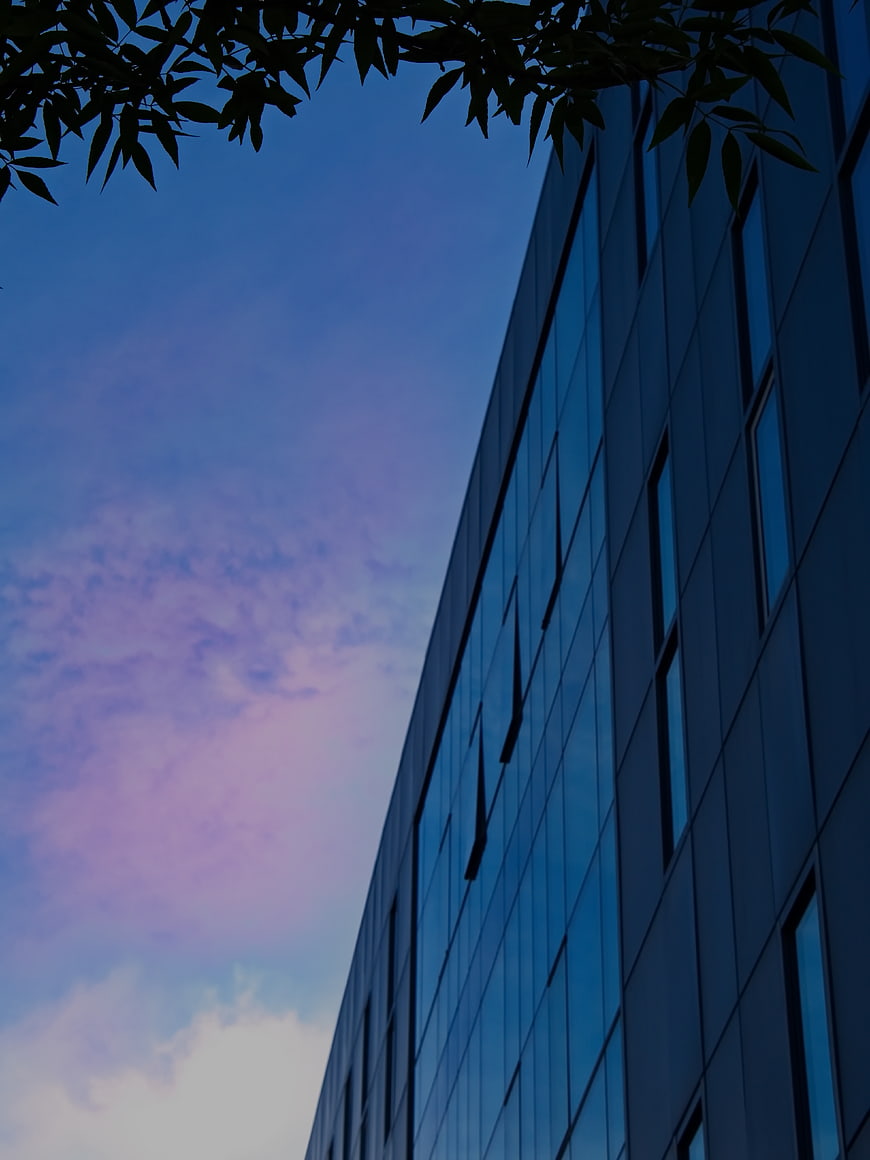 Modern Glass Office Building Against Purple Dusk Sky
