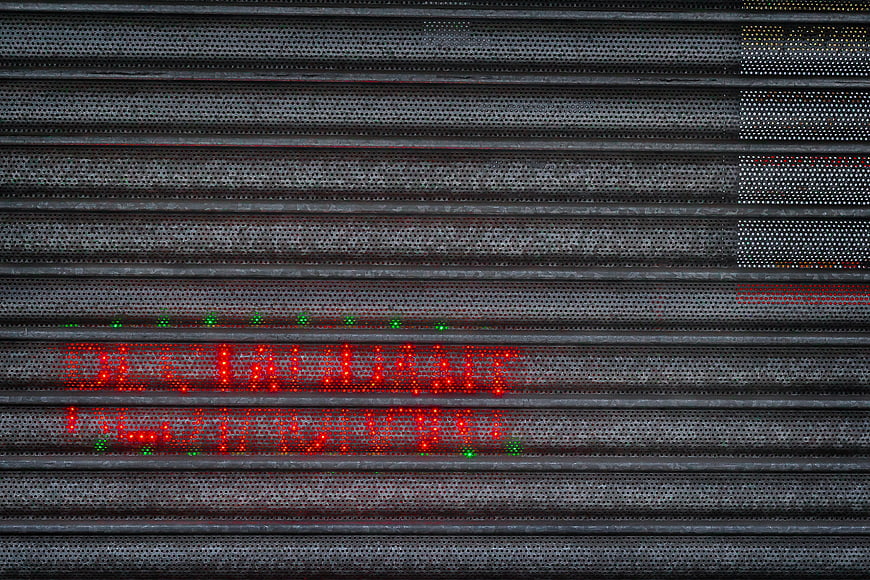 Red LED Open Sign on Perforated Metal Restaurant Wall