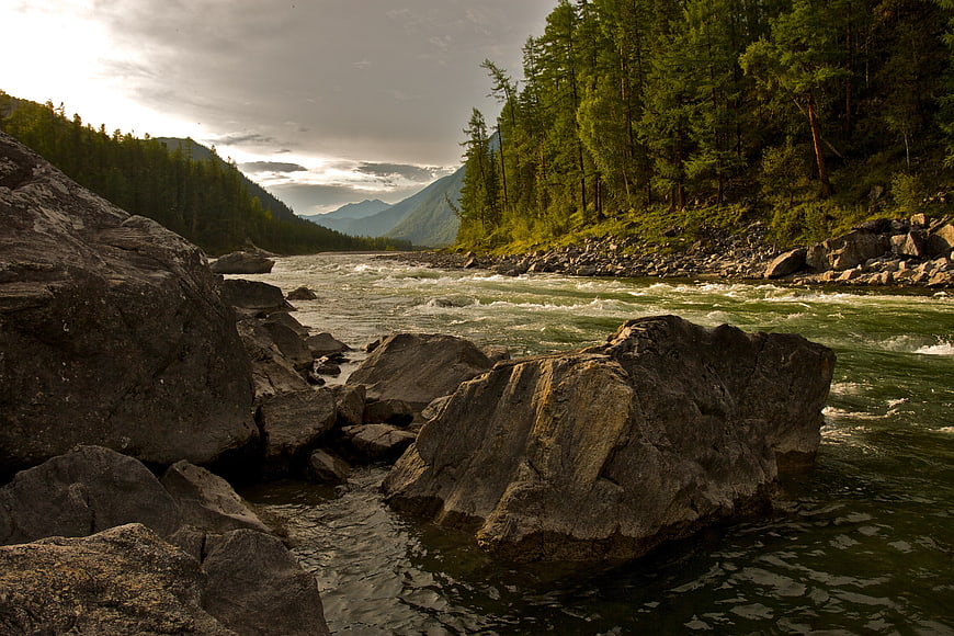 Rushing Mountain River Flowing Past Large Granite Boulders