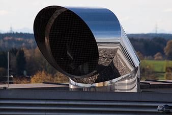 Stainless Steel Ventilation Duct On Rooftop With Autumn Landscape Background