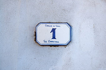 Italian House Number One Sign On White Plaster Wall