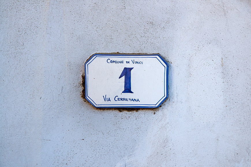 Italian House Number One Sign On White Plaster Wall