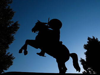 Silhouette of Equestrian Statue Against Deep Blue Evening Sky