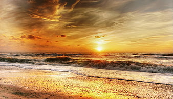 Dramatic Golden Sunset Over Ocean Waves on Sandy Beach