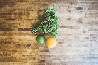 Fresh mint, lime, and orange on wooden cutting board