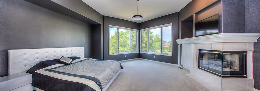 Modern Bedroom with Fireplace and Large Windows