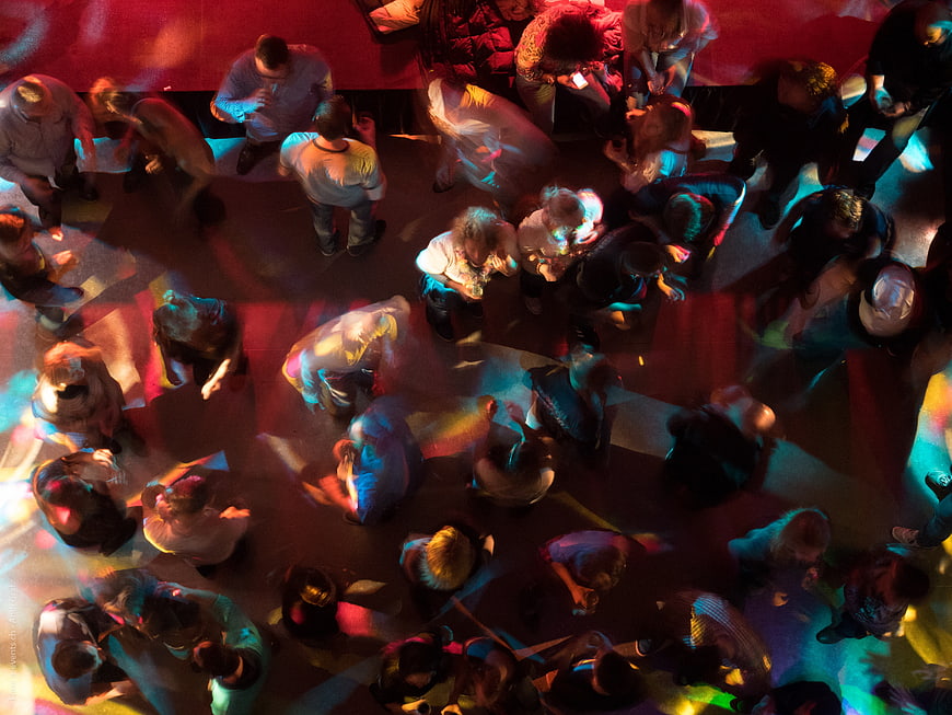 Aerial View of Crowd Dancing in Colorful Disco Lights