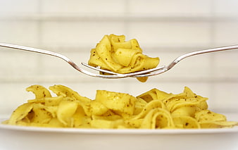Close-up of Tagliatelle Pasta on Fork with Blurred Background