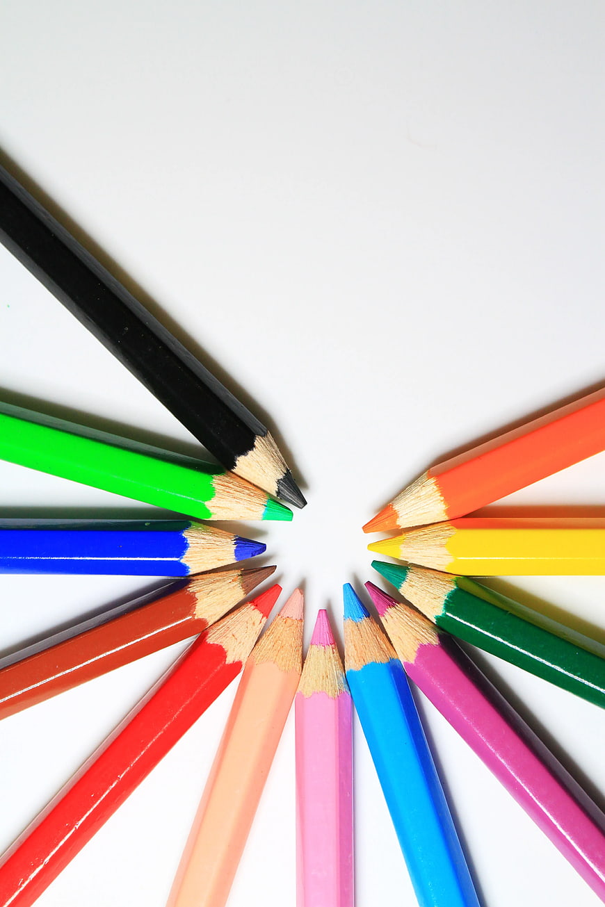Colorful Pencils Arranged in a Circle on White Background