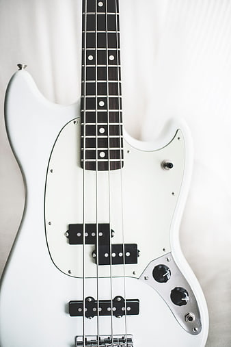 White electric bass guitar on white background