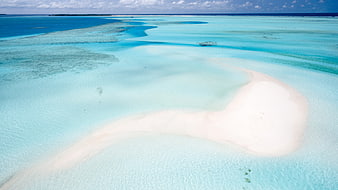 Aerial view of white sandbar in turquoise tropical lagoon