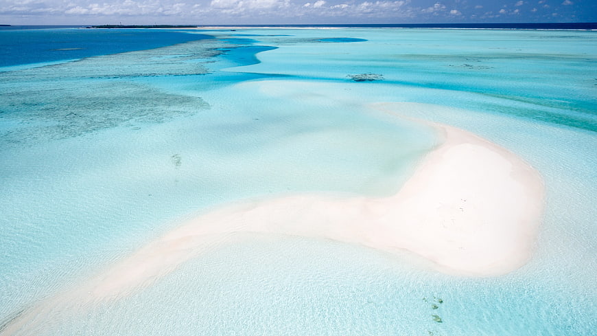 Aerial view of white sandbar in turquoise tropical lagoon