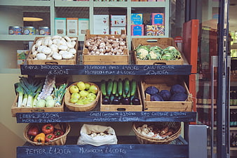 Fresh organic vegetables displayed in wooden crates at a market shop