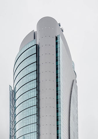 Modern Curved Skyscraper Architecture Against Overcast Sky