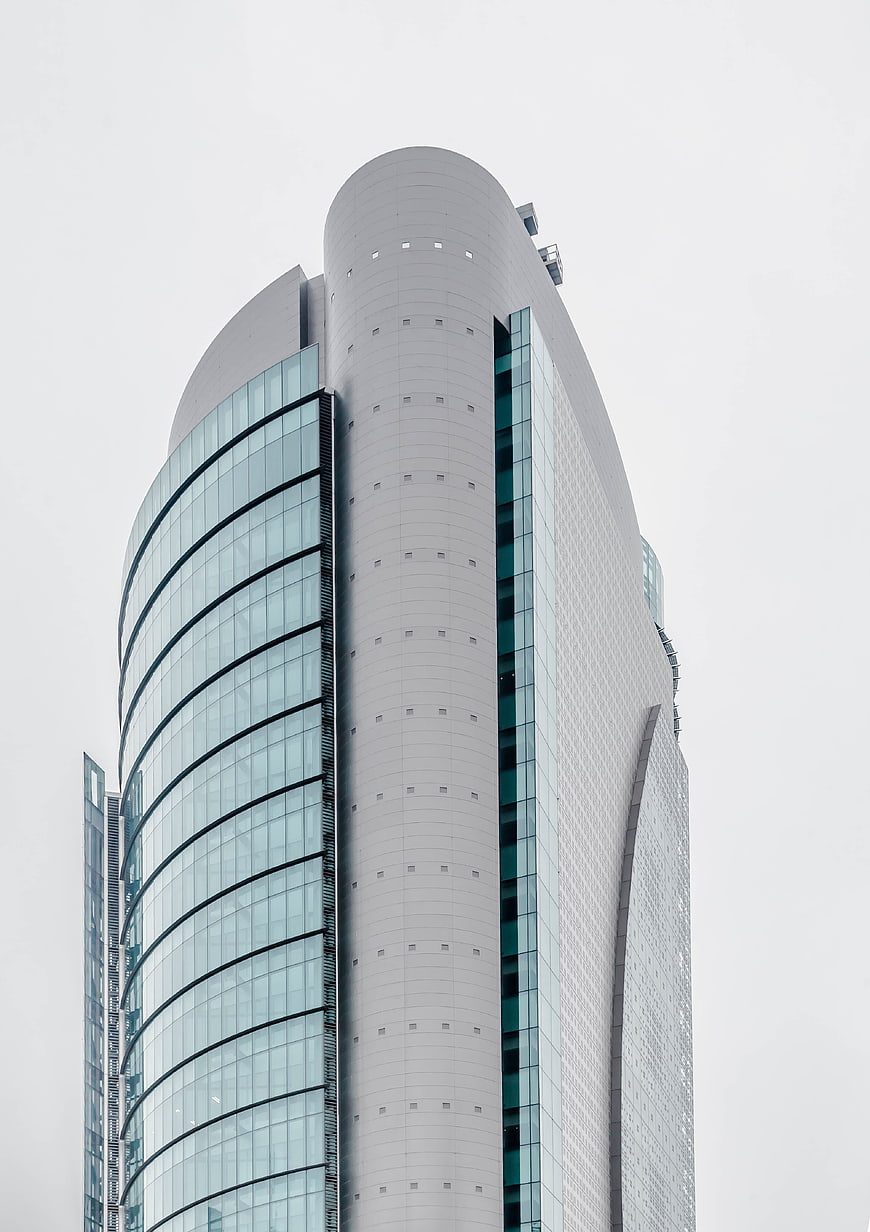 Modern Curved Skyscraper Architecture Against Overcast Sky