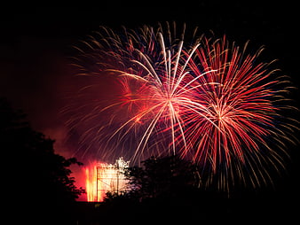 Vibrant Red and White Fireworks Exploding in Night Sky