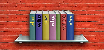 Colorful Books with Question Words on Shelf Against Red Brick Wall