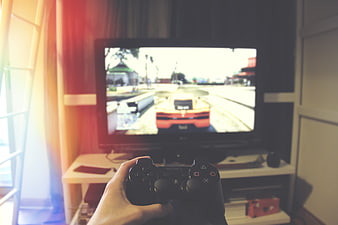 First-person view of playing racing video game on TV
