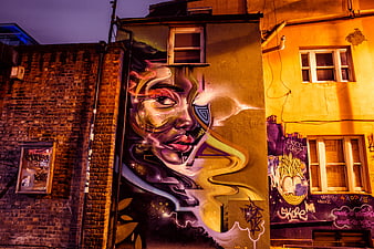 Vibrant Street Art Mural on Urban Wall at Night
