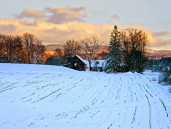 Snowy Vermont Farmhouse at Dawn with Barn and Mountains