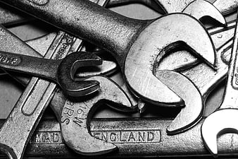 Close-up of vintage metal wrenches and spanners in black and white