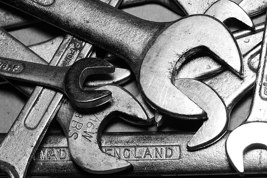 Close-up of vintage metal wrenches and spanners in black and white