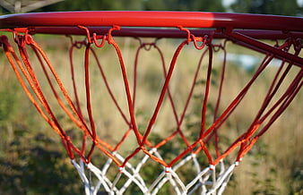 Close-up of red basketball hoop and net outdoors
