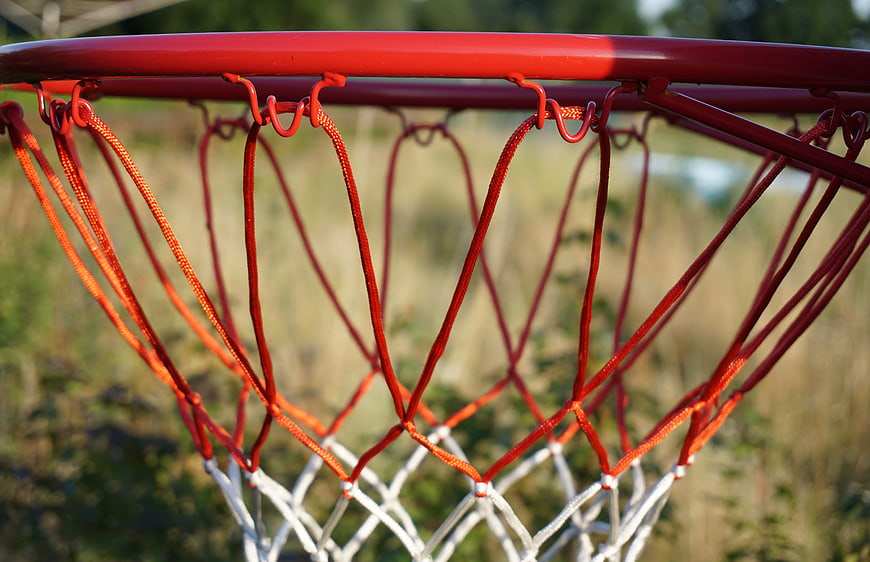 Close-up of red basketball hoop and net outdoors