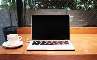Laptop and Coffee Cup on Wooden Table