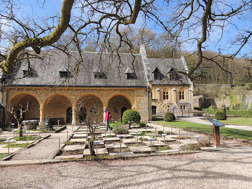 Historic monastery cloister with herb garden and stone arches