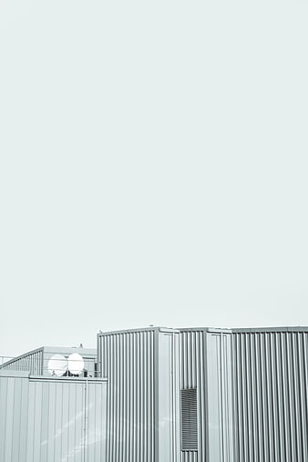 Minimalist industrial architecture with corrugated metal and satellite dishes