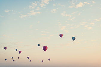 Hot Air Balloons Flying in Pastel Sky at Sunset