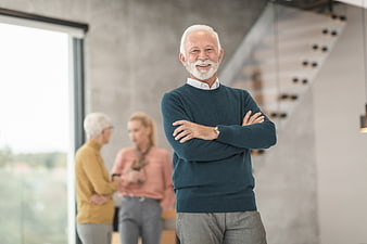 Confident Senior Man in Modern Office with Colleagues