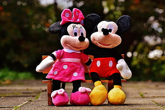 Mickey and Minnie Mouse Plush Toys Sitting on Bench