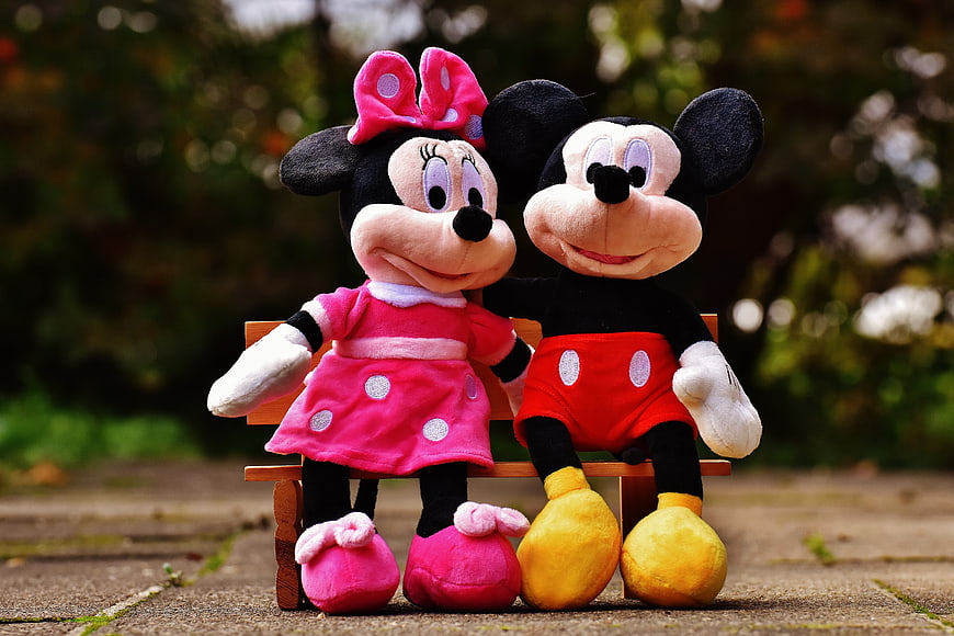 Mickey and Minnie Mouse Plush Toys Sitting on Bench