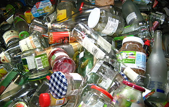 Pile of mixed glass bottles and jars for recycling